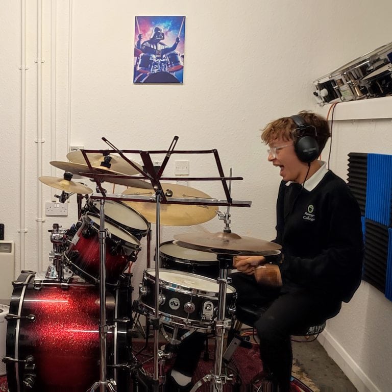 Drum Lessons @ Tricks with Sticks falmouth Boy having a drum lesson in Tricks with Sticks studio